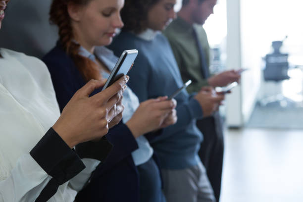 istock Team of business people using mobile phone 892841244
