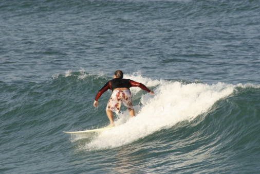 Surfer waxing the board