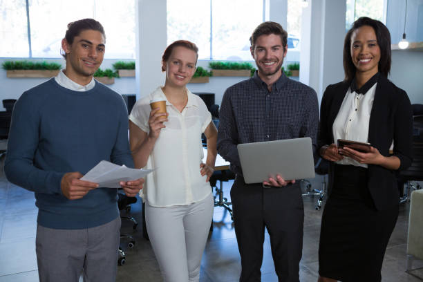 istock Business colleagues standing together in office 892846810