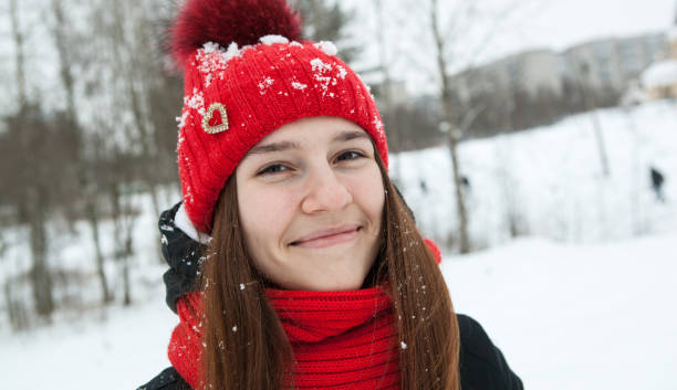 istock A young girl in winter clothes is smiling 892864448