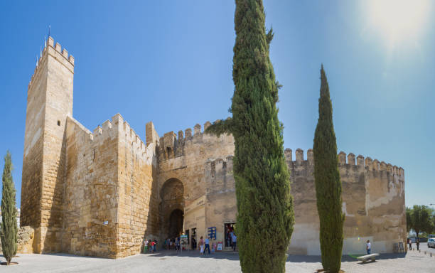 Puerta de Sevilla in Carmona, Andalusia, Spain Carmona, Spain - September 10, 2016: The town gate Puerta de Sevilla in the city of Carmona in Andalusia, Spain. Visitors are passing the entrance. Panorama stitch from several images. carmona stock pictures, royalty-free photos & images