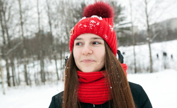 istock A young girl in winter clothes is smiling 892864870