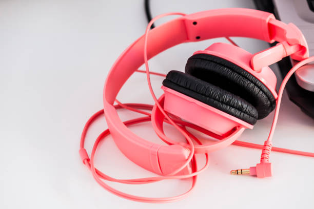 istock Pink headphones on the white computer desk 892865882