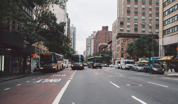 istock Cars On Road Along Buildings 892870512