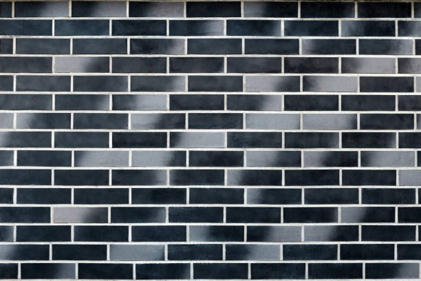 istock Wall (surface) of a black and grey ceramic bricks (tiles) 892871658