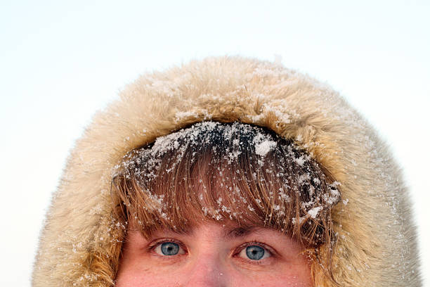 istock woman's blue eyes and hair under snow 89287171