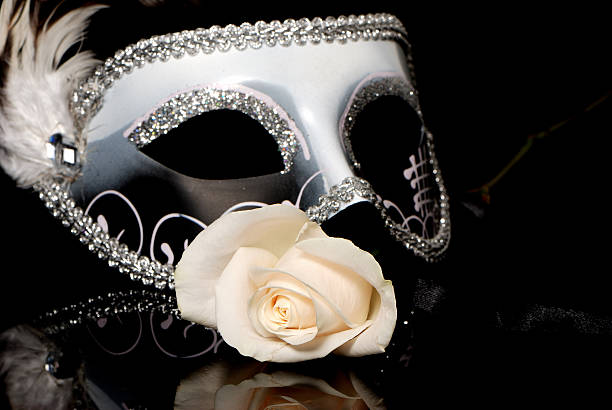 The Venetian mask and flower on a black background stock photo