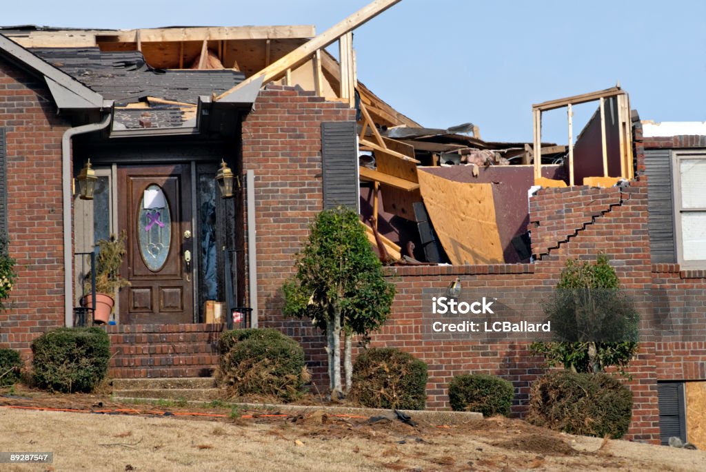 Brick house with the roof destroyed by an EF2 tornado brown brick house destroyed by a tornado. The bricks are split and have shifted as well as the entire roof being ripped off. There was nothing left to salvage. This tornado was rated EF2 and it tracked across north Columbus Georgia and ended 3 miles west of Midland. Tornado Stock Photo