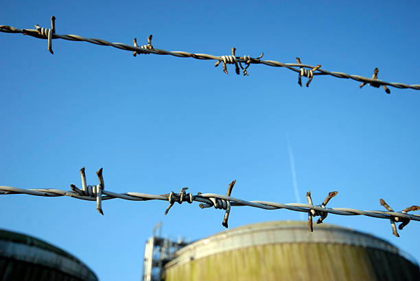 Wire and Chemical Tank  barbed wire wire factory sky stock pictures, royalty-free photos & images