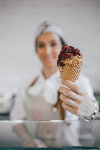 Woman giving customer an ice cream