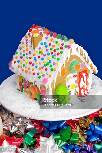 Decorated Gingerbread House On A Cake Stand And Christmas Bows Stock Photo - Download Image Now