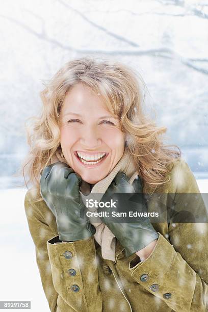 Snow Falling On Smiling Woman Stock Photo - Download Image Now - Winter, Women, One Woman Only