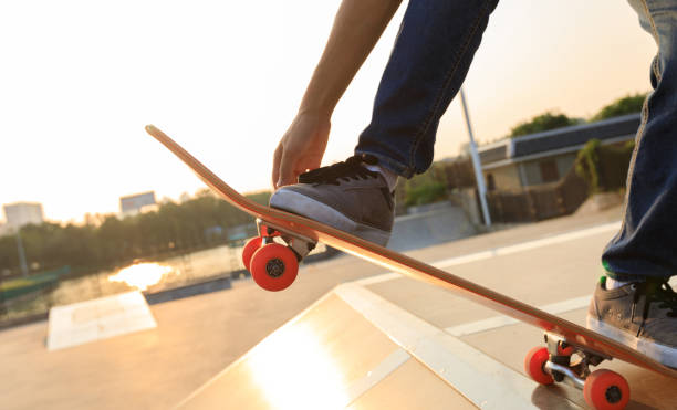 istock skateboarder legs riding skateboard on skatepark ramp 892918244