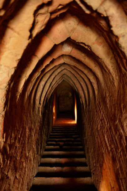 Long, dark corridor illuminated in the middle in ancient buddist temple in Bagan, Myanmar