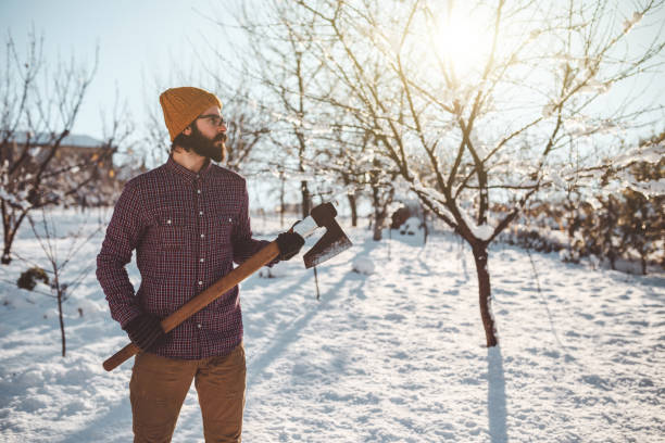 istock Lumbersexual with an ax on a snowy winter day 892929710