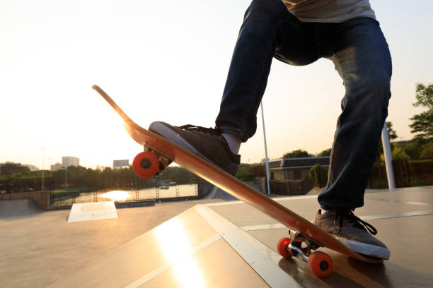 istock skateboarder legs riding skateboard on skatepark ramp 892930442