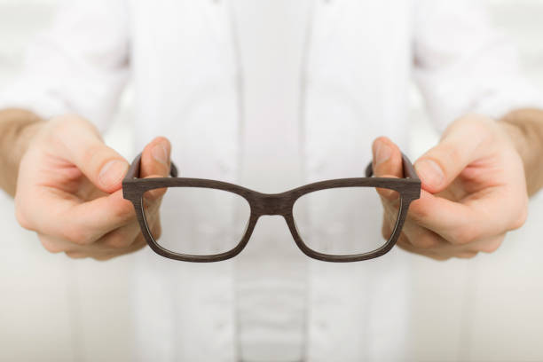 istock doctor hands holding glasses for vision correction 892940808