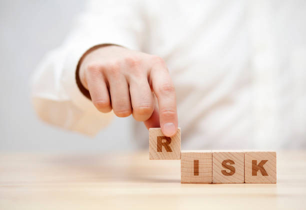 istock Hand and word Risk made with wooden building blocks 892945060