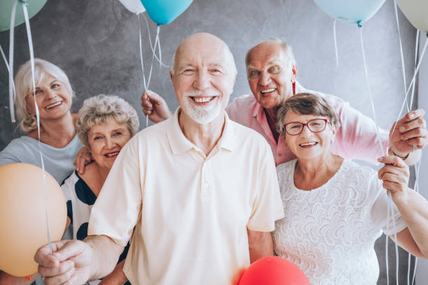 istock Elderly friends enjoying birthday party 892948860