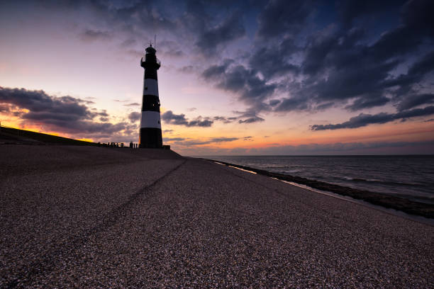istock Sunset over the lighthouse in Berksem, Netherlands. 892956934