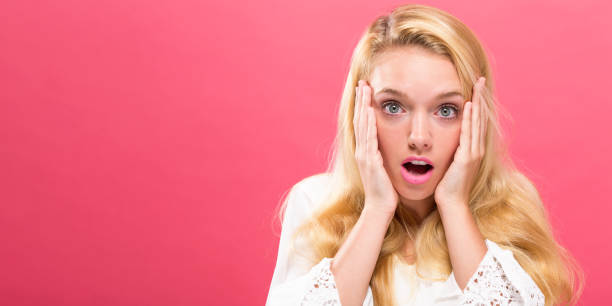 istock Surprised young woman on a bright background 892963034