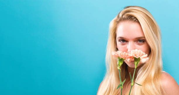 istock Young woman with carnation 892963146