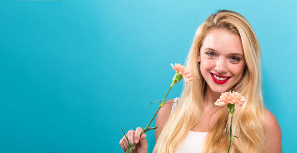 istock Young woman with carnation 892963150