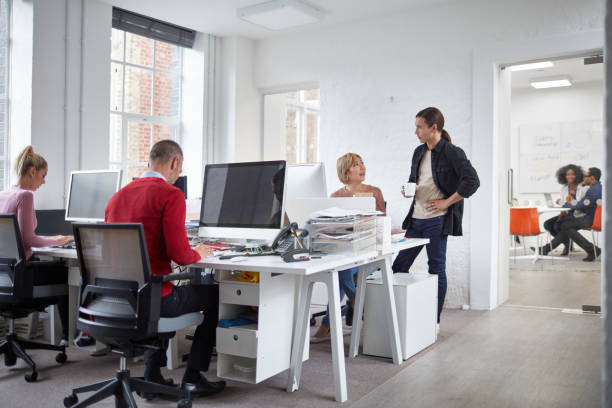 istock Multi-ethnic millennial business people working at office 892974306