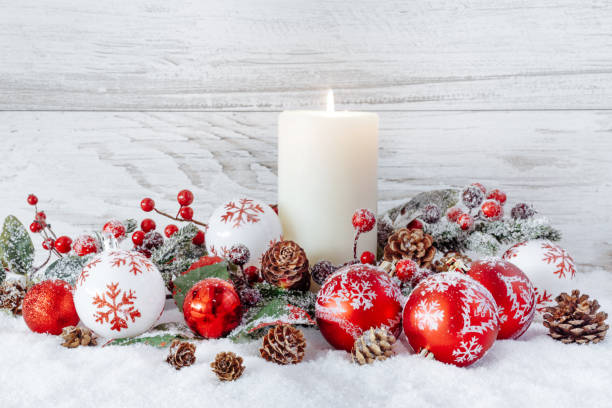 istock White burning candle with christmas decorations 892985706