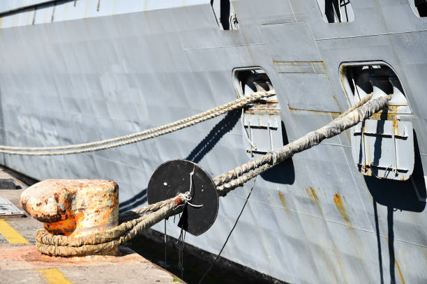 Mooring heavy duty rope in harbor Mooring heavy duty rope used for securing ships in harbor mooring line stock pictures, royalty-free photos & images