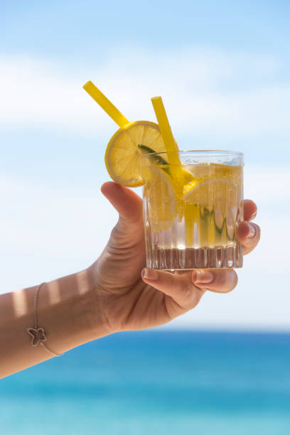 istock Hand holding glass of coctail. 892998200