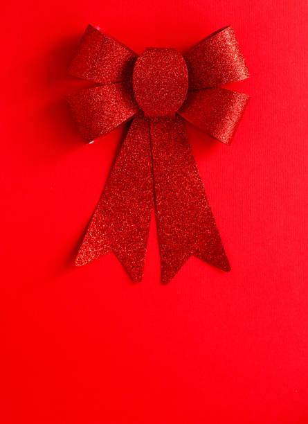 istock Top view of red background with big red bow. Love concept. 892999180