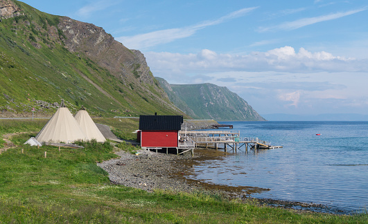 Fishermen's cabins and lavvu, the traditional home of the Sami, northern Norway