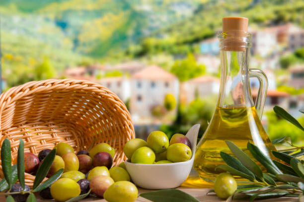 Olives Olives and leaves on the table in the garden. mediterranean sea stock pictures, royalty-free photos & images