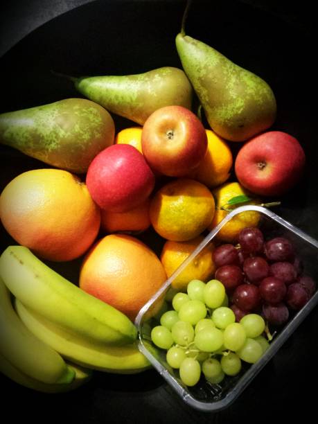 istock Fruit bowl with banana, orange, mandarine, apple, pear and grapes 893008886