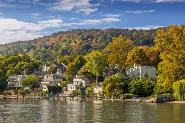 Photo of Landscape with Trees in Autumn Colors (Foliage), Hudson River, Waterfront Houses, Pier and Blue Sky, Nyack, Rockland County, Hudson Valley, New York.