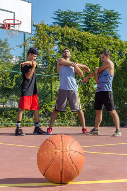 istock Friends stretching before playing basketball 893028922