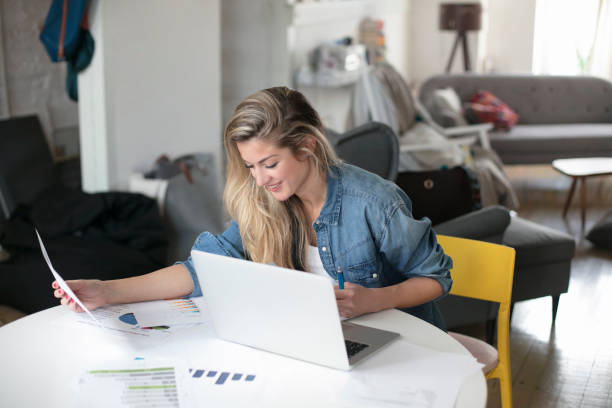istock Young beautiful woman works for a computer from home with laptop on a white desk 893032036