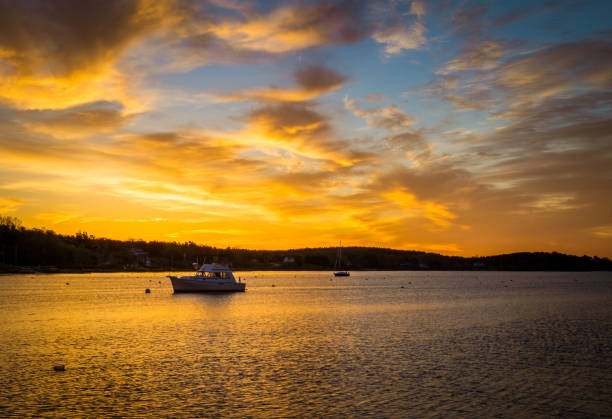 istock sunrise over a fishing boat 893032156