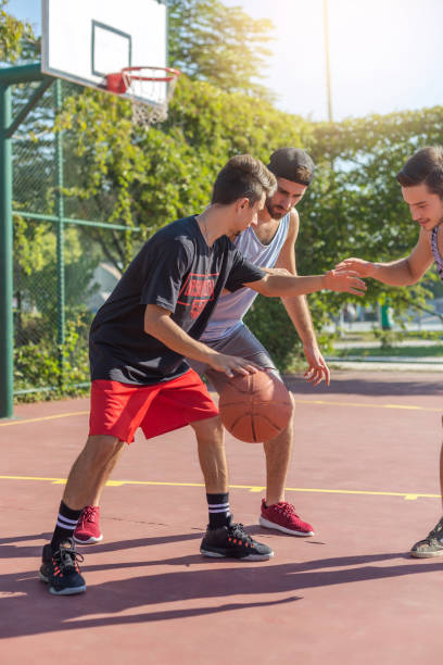 istock Friends playing basketball 893032468
