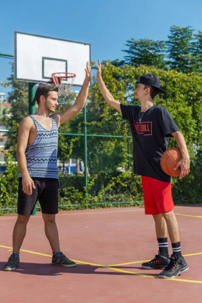 istock Basketball players playing outdoors 893032974