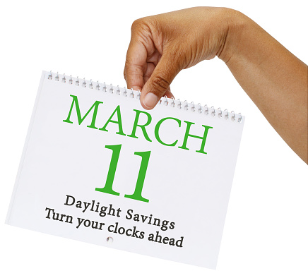 Hand holding March 11 Daylight Savings Calendar white background