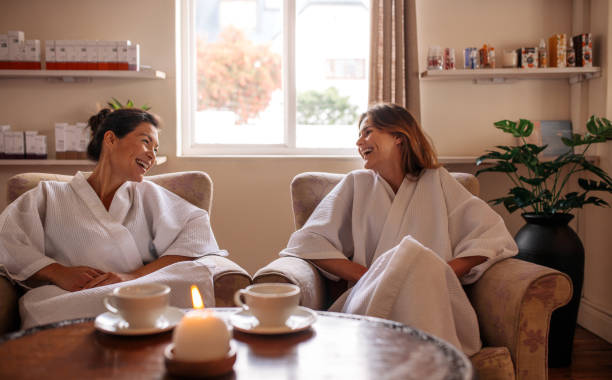 istock Smiling female friends waiting in spa reception area 893044628