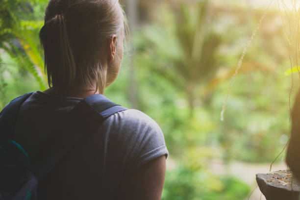istock Woman traveller with backpack in the cave. 893049296
