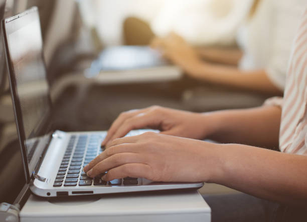 istock Woman using laptop in the airplane. 893049544