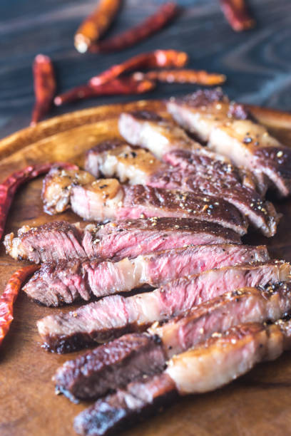 istock Cut beef steak on the wooden board 893049792