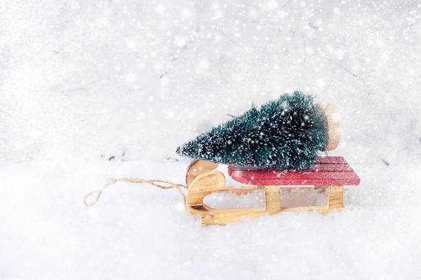 istock Decorative Christmas tree on red sled. Snow texture, copy space. Greeting card. 893058524