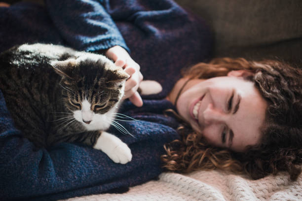 istock Beautiful young girl with her cat 893071062