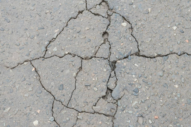 istock Cracks in the pavement. Poor road surfaces. 893076054