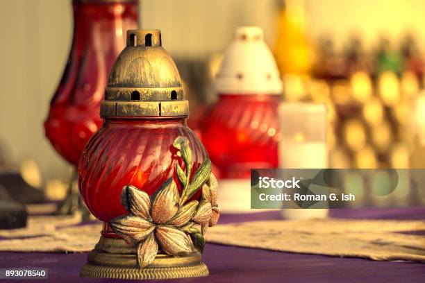 Colorful Vivid Red Catholic Lighting Candles In Lanterns Decorated With Beautiful Ornament All Saints Day Holiday Stock Photo - Download Image Now